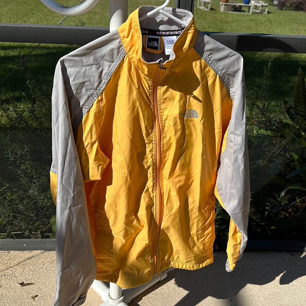 The North Face women's yellow windbreaker lightweight jacket hiking rain